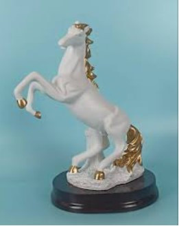 white horse statue with golden work